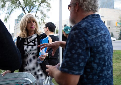 ANDREW RYAN / WINNIPEG FREE PRESS Cathy Cox, minister of sport, culture, and heritage speaks to Taras Manzie president of Lake of the Woods Brewing Company at the launch of Manyfest at memorial park on August 14, 2018.