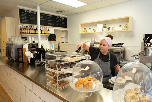 ANDREW RYAN / WINNIPEG FREE PRESS Lisa Benham grabs a pastry for a customer at the newly opened Canteen café on Stafford St. on August 14, 2018.