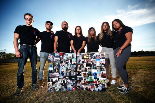 JOHN WOODS / WINNIPEG FREE PRESS
Rodell and Jennifer Bautista, holding photos of her son Gabriel Pereira, who died of a meth overdose two weeks ago, are photographed with their children, from left, Dylan Pereira, Khaeler, Mileena, Alyssa, and Nikaya Bautista  outside the Sturgeon Creek Community Centre after an information night about a proposed St James addictions centre Tuesday, August 14, 2018.