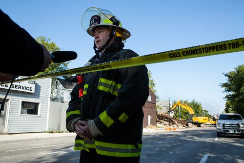 ANDREW RYAN / WINNIPEG FREE PRESS Assistant Winnipeg Fire Department Chief Jason Shaw speaks to media about the departments use of a drone to aid fighting the overnight fire on Selkirk Ave. while a demolition crew tears down the rooming house that caught fire on Selkirk Ave. on August 15, 2018.