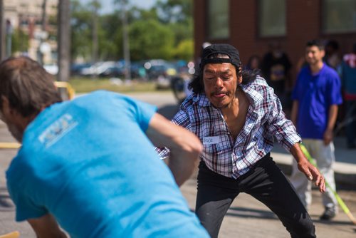 MIKAELA MACKENZIE / WINNIPEG FREE PRESS
Dougie Bruce reaches for the ball during a pickup street hockey game hosted by the Main Street Project on Martha Street in Winnipeg on Wednesday, Aug. 15, 2018. 
Winnipeg Free Press 2018.