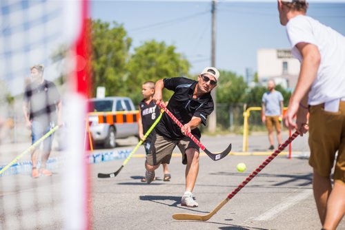 MIKAELA MACKENZIE / WINNIPEG FREE PRESS
Mike DeGroot shoots the ball at a pickup street hockey game hosted by the Main Street Project on Martha Street in Winnipeg on Wednesday, Aug. 15, 2018. 
Winnipeg Free Press 2018.