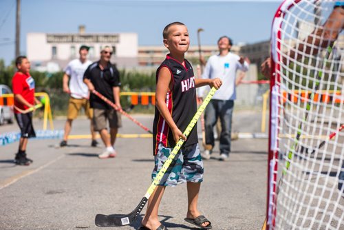 MIKAELA MACKENZIE / WINNIPEG FREE PRESS
Jeremiah Longbottom, seven, plays a pickup street hockey game hosted by the Main Street Project on Martha Street in Winnipeg on Wednesday, Aug. 15, 2018. 
Winnipeg Free Press 2018.