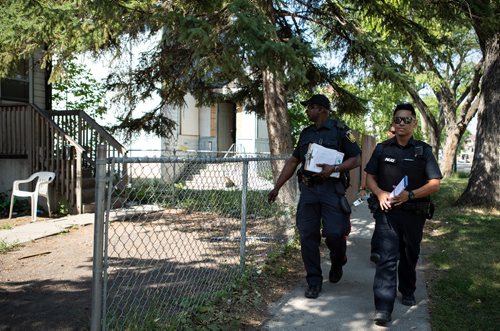 ANDREW RYAN / WINNIPEG FREE PRESS Constable Missen Odidison walks with Constable Orlando Budahan as they speak to residents in the William Whyte neighbourhood about the Make the Right Call campaign, part of the Winnipeg Police's attempt to increase their positive presence in the city's north end neighbourhood on Manitoba Ave. on August 15, 2018.