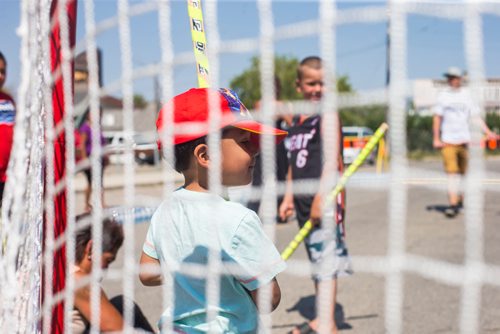 MIKAELA MACKENZIE / WINNIPEG FREE PRESS
Jace McKay, three, plays a pickup street hockey game hosted by the Main Street Project on Martha Street in Winnipeg on Wednesday, Aug. 15, 2018. 
Winnipeg Free Press 2018.