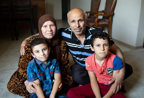 ANDREW RYAN / WINNIPEG FREE PRESS Amina Al Mohammed Al Issa and Hasan Alhamid Aldkhalaf pose with their younger sons Abdullah, left, and Mahmoud for a portrait in their home on August 15, 2018. The Syrian refugees received notice that their son, who is currently in Lebanon, received his notice to serve in the Lebanese military in six months.