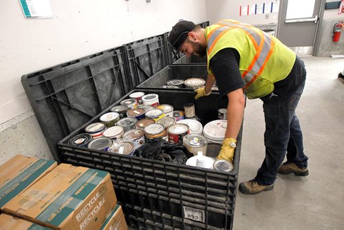 PHIL HOSSACK / WINNIPEG FREE PRESS -  A city worker packs partially full paint containers into a crate at the city's newest 4R Recycling Depot on Panet Road Thursday. See Jill Wilson's story. - August 15, 2018
