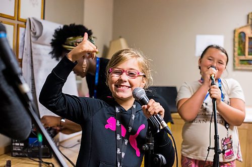 MIKAELA MACKENZIE / WINNIPEG FREE PRESS

Mia Tellier-Lalonde hams it up for the camera during vocals class at the inaugural Girls Rock Winnipeg, a new day camp in which girls and non-binary youth form a band, write a song, record, and perform in the space of a week, at the West End Cultural Centre in Winnipeg on Wednesday, Aug. 15, 2018. 

Winnipeg Free Press 2018.