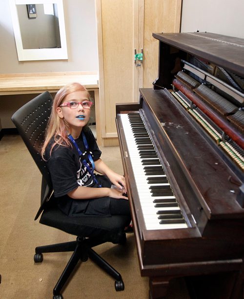 PHIL HOSSACK / WINNIPEG FREE PRESS - 10 Yr old Mia Tellier-Lalonde sits improvisin g on a 'Green Room" piano before singing in her band at "GirlsRock" Saturday. See Jenn Zoratti story.  - August 17, 2018telli