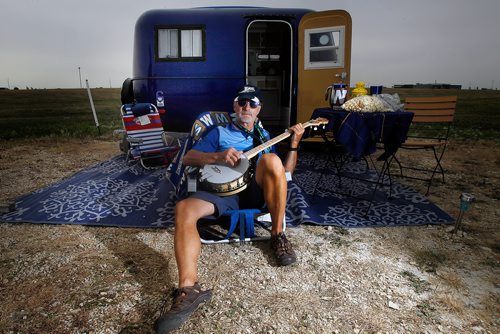 PHIL HOSSACK / WINNIPEG FREE PRESS - Just down the row from a Saskatchewan Rough Riders themed camper, Ron Miechkota picks his banjo for effect on display with many other of the Boler Campers at Exhibition grounds Saturday. See Melissa Martin's story.  - August 17, 2018