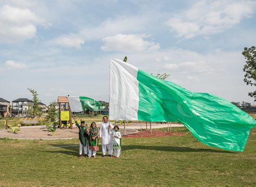 DAVID LIPNOWSKI / WINNIPEG FREE PRESS

(L-R) Son Labeeb, mom Nuzhat Farooqui, daughter Tehreem, and dad Abid Siddiqi pose with Pakistan's flag at Jinnah Park prior to the beginning of festivities celebrating Pakistan's Independence Day and Eid Sunday August 19, 2018.