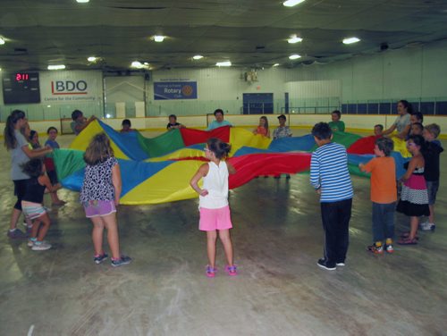 Canstar Community News Aug. 13, 2018 - Youth and counsellors play a parachute game at Recereation Opportunities for Kids Central's summer camp at the BDO Centre in Portage la Prairie. (ANDREA GEARY/CANSTAR COMMUNITY NEWS)