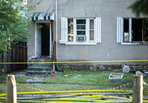 ANDREW RYAN / WINNIPEG FREE PRESS Firefighters look onto the wreckage that has been left of a home that caught fire early morning in the city's North End on August 21, 2018.