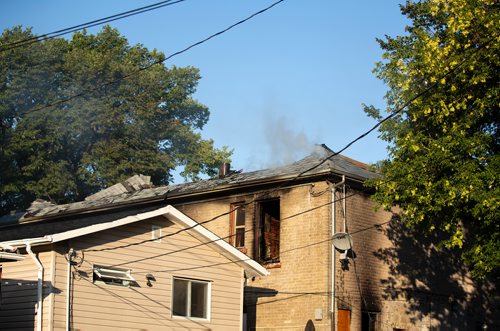 ANDREW RYAN / WINNIPEG FREE PRESS Smoke rises from the wreckage that has been left of a home that caught fire early morning in the city's North End on August 21, 2018.
