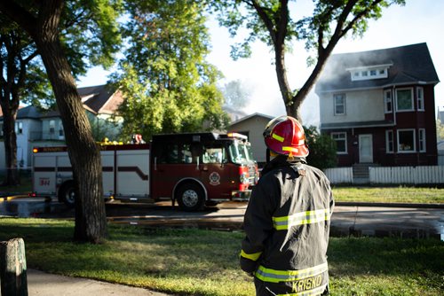ANDREW RYAN / WINNIPEG FREE PRESS Firefighters look onto the wreckage that has been left of a home that caught fire early morning on Manitoba Ave. in the city's North End on August 21, 2018.