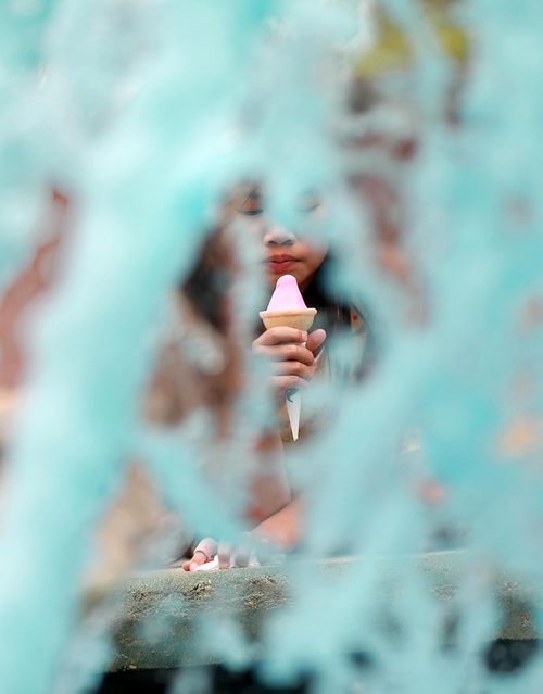 RUTH BONNEVILLE / WINNIPEG FREE PRESS

Eight-year-old Kylie Lange smiles at her mom while eating her pink gelato cone as she checks out the blue fountain water at a small park on Hugo and Jessie Street Thursday afternoon.

The two had just been to Nucci's Gelati enjoying the warm weather and last few days of summer before heading back to school. 

Standup photo 

August 23/18
