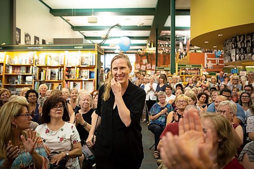 ANDREW RYAN / WINNIPEG FREE PRESS Author Miriam Toews walks towards the podium through a packed house of fans at McNally's on August 23, 2018.