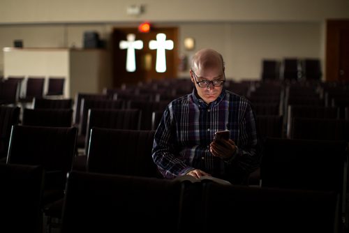 ANDREW RYAN / WINNIPEG FREE PRESS Media Studies professor Nicholas Greco, of Providence University College in Otterbourne, has committed himself to condensing and tweeting out three articles of the Catholic Cathecism daily, a process that he says will take 3.5 years. Greco poses for a portrait in a campus chapel on August 24, 2018.