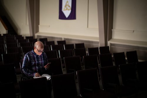 ANDREW RYAN / WINNIPEG FREE PRESS Media Studies professor Nicholas Greco, of Providence University College in Otterbourne, has committed himself to condensing and tweeting out three articles of the Catholic Cathecism daily, a process that he says will take 3.5 years. Greco poses for a portrait in a campus chapel on August 24, 2018.