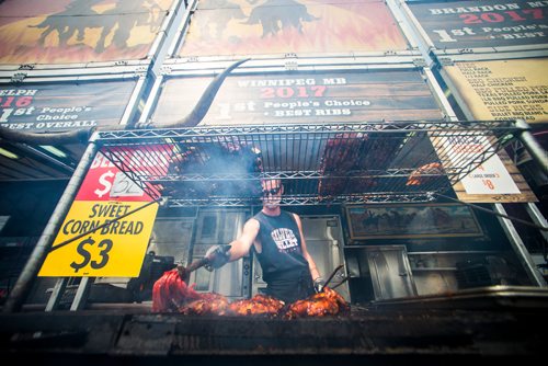 MIKAELA MACKENZIE / WINNIPEG FREE PRESS
Carter Niklaus mops sauce onto ribs a the Silver Bullet BBQ at Ribfest at the Forks in Winnipeg on Friday, Aug. 24, 2018.
Winnipeg Free Press 2018.