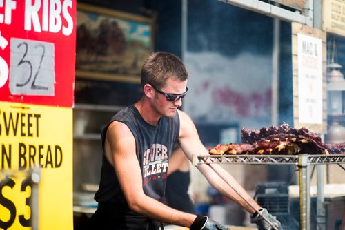 MIKAELA MACKENZIE / WINNIPEG FREE PRESS
Carter Niklaus mops sauce onto ribs a the Silver Bullet BBQ at Ribfest at the Forks in Winnipeg on Friday, Aug. 24, 2018.
Winnipeg Free Press 2018.