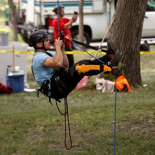 PHIL HOSSACK / WINNIPEG FREE PRESS -   DJ Neustaeder checks his gear close to the ground before beginning his ascent into the canopy in Kildonan Park Saturday Morning at the International Society of Aboriculture Prairie Chapter's 25th annual Tree Climbing   Championship. See Eric Pindera's story. - August 25, 2018