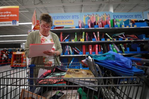 RUTH BONNEVILLE / WINNIPEG FREE PRESS

Standup photo 
Families take advantage of the cool weather to do their back-to-school shopping with their kids at Walmart on Grant on Monday afternoon. 

Alexis Anderson checks off her granddaughter Alarra Anderson's  grade 7 school supply list in the binder aisle as Alarra looks for other supplies Monday. 

August 27/18

