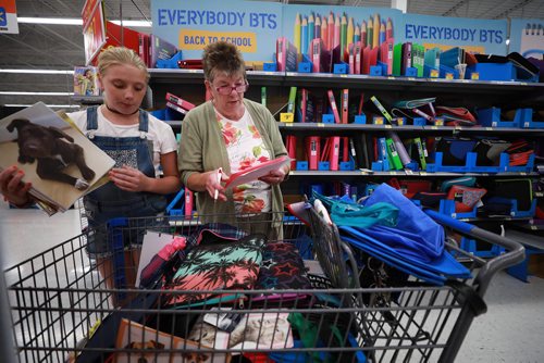 RUTH BONNEVILLE / WINNIPEG FREE PRESS

Standup photo 
Families take advantage of the cool weather to do their back-to-school shopping with their kids at Walmart on Grant on Monday afternoon. 

Alarra Anderson looks over the supplies she has in her cart as her grandmother, Alexis Anderson checks off her granddaughter's grade 7 school supply list in the binder aisle Monday. 

August 27/18
