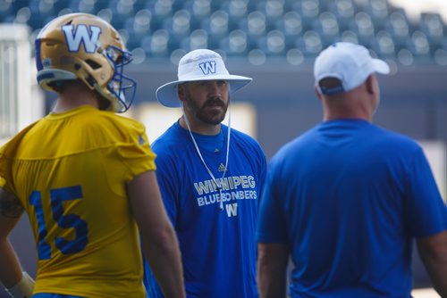 MIKE DEAL / WINNIPEG FREE PRESS
Winnipeg Blue Bombers' quarterback coach Buck Pierce (centre) and Offensive Coordinator and Receivers Coach Paul LaPolice (right) with starting QB Matt Nichols (15) during practice at Investors Group Field Thursday morning. 
180830 - Thursday, August 30, 2018.