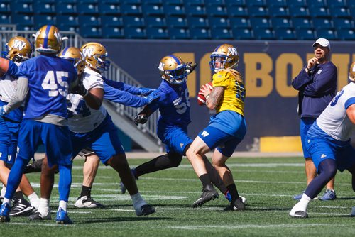 MIKE DEAL / WINNIPEG FREE PRESS
Winnipeg Blue Bombers' quarterback Bryan Bennett (18) gets ready to thrown the ball while Gerald Rivers (56) rolls in for the sack during practice at Investors Group Field Thursday morning. 
180830 - Thursday, August 30, 2018.