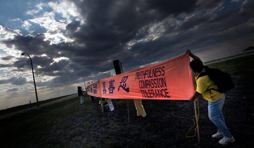 PHIL HOSSACK / WINNIPEG FREE PRESS -  Falun Dafa arrange their protest banners at the entrance to the Chinese Northern Lights exhibition Friday. See Carol Sanders story.  - August 31, 2018