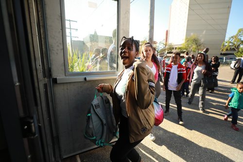 RUTH BONNEVILLE / WINNIPEG FREE PRESS
Feature Story: Freedom International School on the first day of school.
Story: Volunteers converted an electrical shop on Notre Dame Ave. into a school for newcomer kids ages 13-21 whose reading and basic academic skills are at least two years behind their Canadian peers.
Former police chief Devon Clunis gave opening blessing to volunteer teachers and approx. 20 students.
Plamedie Gatoro from the Congo can't hold back her excitement as she heads into the school with other students in line behind her, Wednesday.
Carol Sanders | Reporter
September 5/18