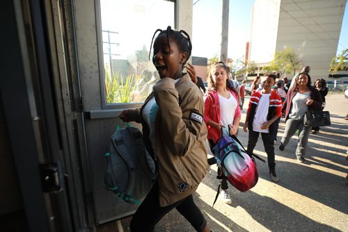RUTH BONNEVILLE / WINNIPEG FREE PRESS
Feature Story: Freedom International School on the first day of school.
Story: Volunteers converted an electrical shop on Notre Dame Ave. into a school for newcomer kids ages 13-21 whose reading and basic academic skills are at least two years behind their Canadian peers.
Former police chief Devon Clunis gave opening blessing to volunteer teachers and approx. 20 students.
Plamedie Gatoro from the Congo can't hold back her excitement as she heads into the school with other students in line behind her, Wednesday.
Carol Sanders | Reporter
September 5/18