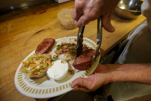 MIKE DEAL / WINNIPEG FREE PRESS
Nathan Detroit's Lunch Pad, 1 Lombard Place (directly beneath the Richardson Bldg/Fairmont Hotel) 
Cook, Penny gets a plater of Fridays Perogies and Kubi ready.
180906 - Thursday, September 06, 2018.