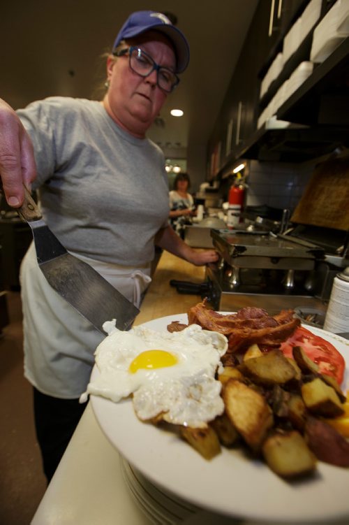 MIKE DEAL / WINNIPEG FREE PRESS
Nathan Detroit's Lunch Pad, 1 Lombard Place (directly beneath the Richardson Bldg/Fairmont Hotel) 
Holly Morris, catering specialist, plates a sunny side breakfast plate.
180906 - Thursday, September 06, 2018.