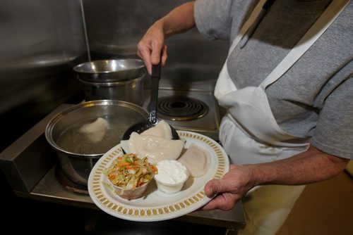 MIKE DEAL / WINNIPEG FREE PRESS
Nathan Detroit's Lunch Pad, 1 Lombard Place (directly beneath the Richardson Bldg/Fairmont Hotel) 
Cook, Penny gets a plater of Fridays Perogies and Kubi ready.
180906 - Thursday, September 06, 2018.