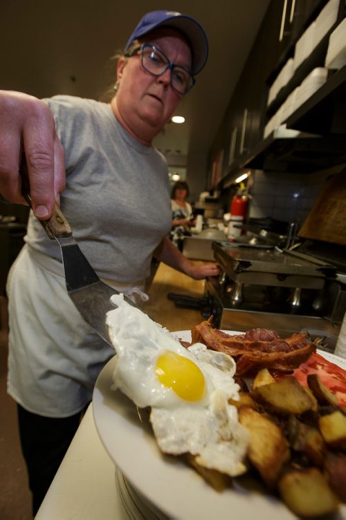 MIKE DEAL / WINNIPEG FREE PRESS
Nathan Detroit's Lunch Pad, 1 Lombard Place (directly beneath the Richardson Bldg/Fairmont Hotel) 
Holly Morris, catering specialist, plates a sunny side breakfast plate.
180906 - Thursday, September 06, 2018.