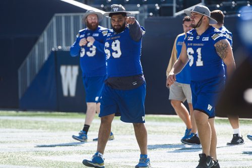 MIKE DEAL / WINNIPEG FREE PRESS
Winnipeg Blue Bombers' Sukh Chungh (69) and the rest of the offensive line walk onto the field for practice at Investors Group Field Friday morning.
180907 - Friday, September 07, 2018.