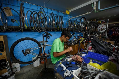 MIKE DEAL / WINNIPEG FREE PRESS
The WRENCH shop at 1057 Logan Avenue.
Pat Krawec, Co-Executive Director at The WRENCH is asking everyone to bring unwanted bicycles to 4R Winnipeg Depots this weekend instead of leaving them at the curb.
Steven Maytwayashing patently takes dirty corroded parts off a bike to clean them during the UpCycle WE Build workshop at The WRENCH. 
180907 - Friday, September 07, 2018.