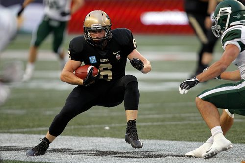 PHIL HOSSACK / WINNIPEG FREE PRESS -  Manitoba Bisons #6 Dylan Schrot takes evasive action against incoming Saskatchewan Huskies defence Friday at Invetor's Group Field. - Sept 7, 2018