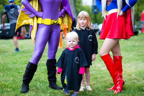 MIKAELA MACKENZIE / WINNIPEG FREE PRESS
Sadie (left) and Braelyn Klassen pose with superheroes at the fourth annual Superhero Run to Fight Childhood Brain Cancer at Kildonan Park in Winnipeg on Saturday, Sept. 8, 2018. 
Winnipeg Free Press 2018.