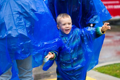 MIKAELA MACKENZIE / WINNIPEG FREE PRESS
Kellen MacKay, three, discovers the arms in his rain poncho at Manyfest in Winnipeg on Saturday, Sept. 8, 2018. 
Winnipeg Free Press 2018.