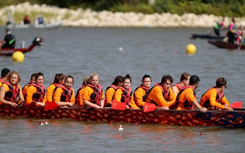 TREVOR HAGAN / WINNIPEG FREE PRESS
Katie's Krew, a team named after Katie Sierhuis, 16, third from left, participates in a flower and pebble ceremony during the CancerCare Manitoba Dragon Boat Festival honouring those who have lost their fight against cancer and those still in treatment, Sunday, September 9, 2018, 2018.