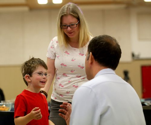 TREVOR HAGAN / WINNIPEG FREE PRESS
Mathew Spears, 7, a cochlear implant recipient, with his mother, Erin, speaking to audiologist, Jacob Sulkers, Sunday, September 9, 2018, 2018. Mathew is one of more than 200 patients who gathered at Waverly Heights Community Centre to celebrate after HSC Surgical Hearing Implant Program reached the milestone of having performed 250 implants.