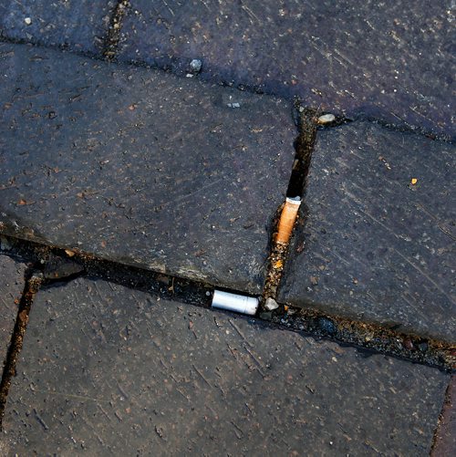 PHIL HOSSACK / WINNIPEG FREE PRESS - Cigarette buts between the paving stones on Lombard. See story. - Sept 10, 2018