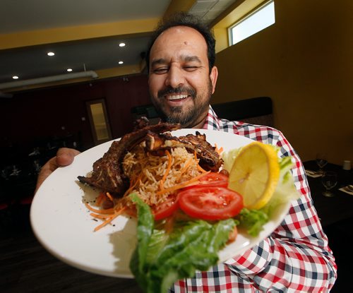 PHIL HOSSACK / WINNIPEG FREE PRESS - Resto Review Pakistani Grill. Owner Jehangir Khan shows off his Pulao Lamb Chops. See story.  - Sept 10, 2018