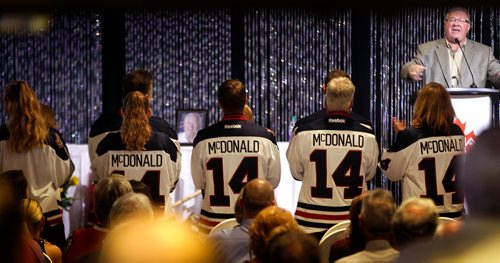 PHIL HOSSACK / WINNIPEG FREE PRESS -  Alvin 'Ab' McDonald's family, wearing Winnipeg Jets Jerseys with his name stand during the memorial service/celebration of the WInnipeg Jets first Captain as Jim Benzalock (upper right) leads the crowd in song Tuesday afternoon at Canad Inns Polo Park. See Ashley's story. - Sept 11, 2018