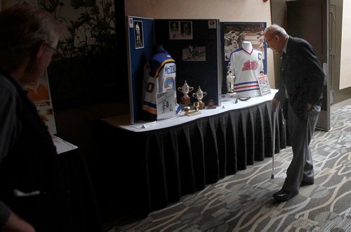 PHIL HOSSACK / WINNIPEG FREE PRESS -  A friend views memoribilia of Alvin 'Ab' McDonald at the memorial service/celebration of the WInnipeg Jets first Captain  Tuesday afternoon at Canad Inns Polo Park. See Ashley's story. - Sept 11, 2018