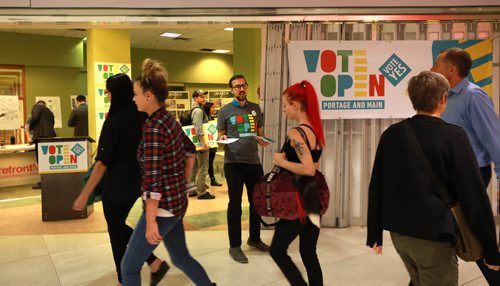 RUTH BONNEVILLE / WINNIPEG FREE PRESS 


John Luxford, a supporter of opening Portage and Main Street to pedestrian traffic, hands out info to people passing the new Vote Open campaign storefront at 201 Portage (in the former TD bank branch in the concourse) over the lunch hour on Tuesday.




September 11/18 
