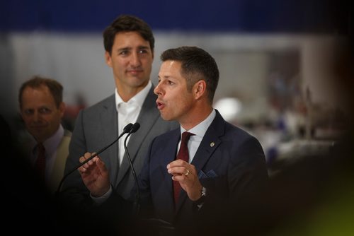 MIKE DEAL / WINNIPEG FREE PRESS
Prime Minister Justin Trudeau looks on while Winnipeg Mayor Brian Bowman talks during a press conference at a new 700 employee Canada Goose manufacturing facility in Winnipeg. 
180911 - Tuesday, September 11, 2018.